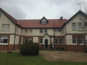 a large house with a red roof and white windows