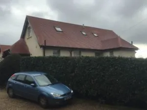 a blue car parked in front of a house
